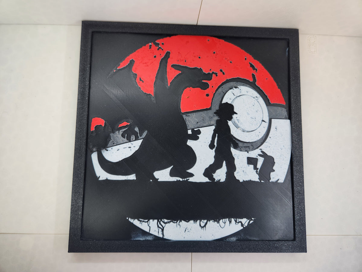 3D printed black framed wall art featuring red and white silhouettes of Charizard, Ash, and Pikachu.