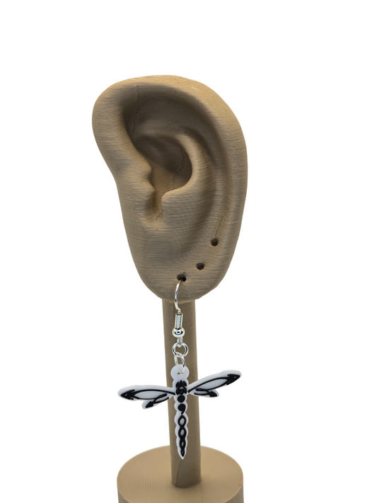 Dragonfly-shaped earring on a mannequin ear with a white background