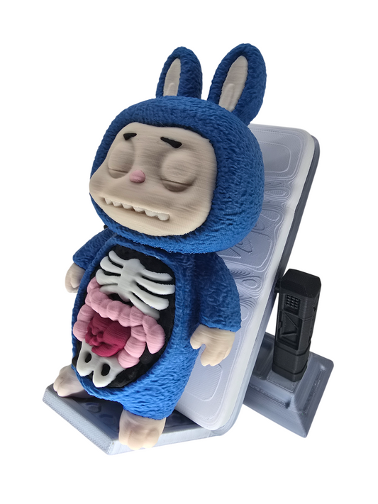 3D printed blue Labubu figure with an exposed skeletal and organ anatomy on a grey display stand.