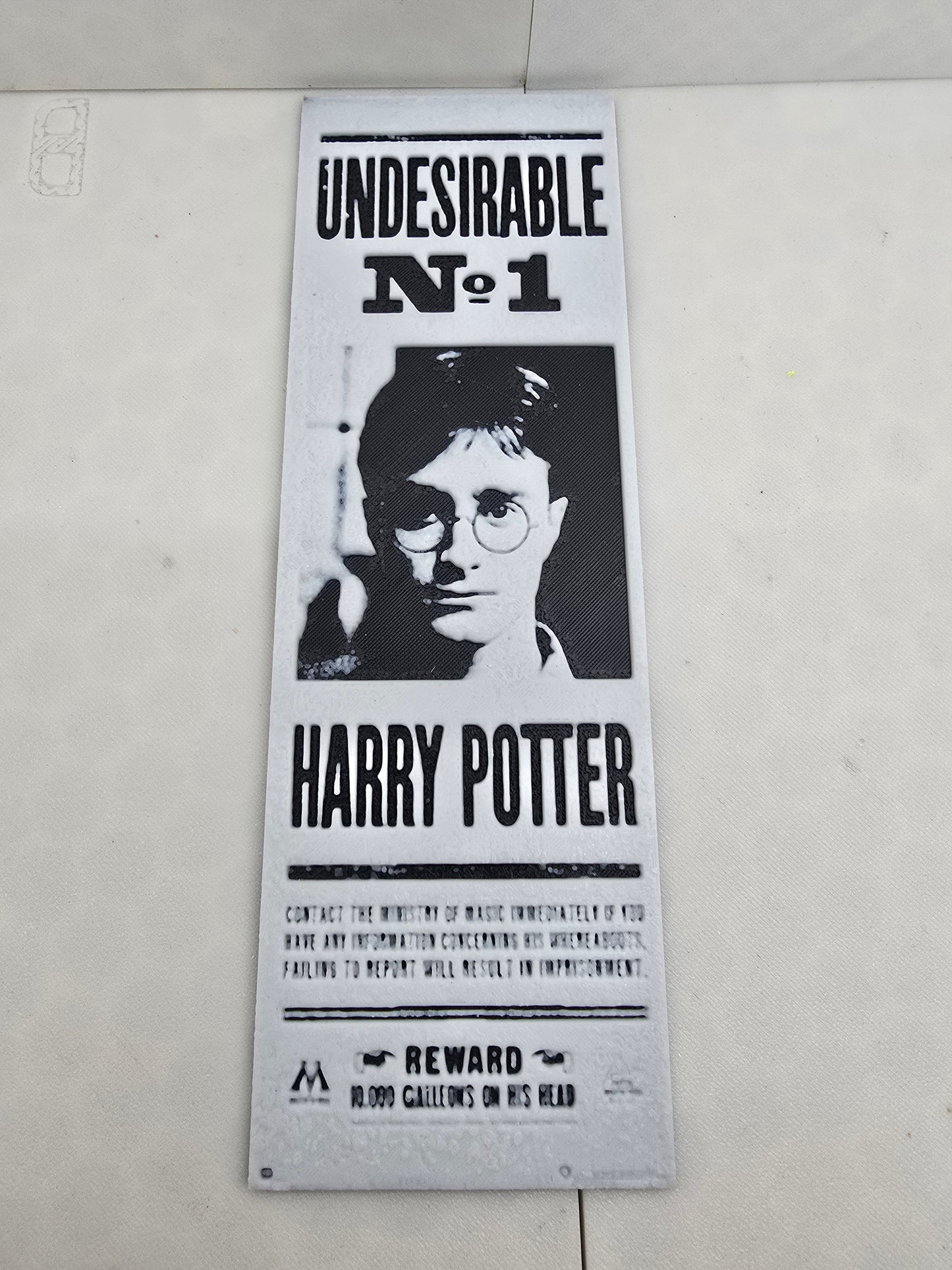 A Harry Potter wanted poster bookmark hangs on the wall, promising a reward for its return if found.