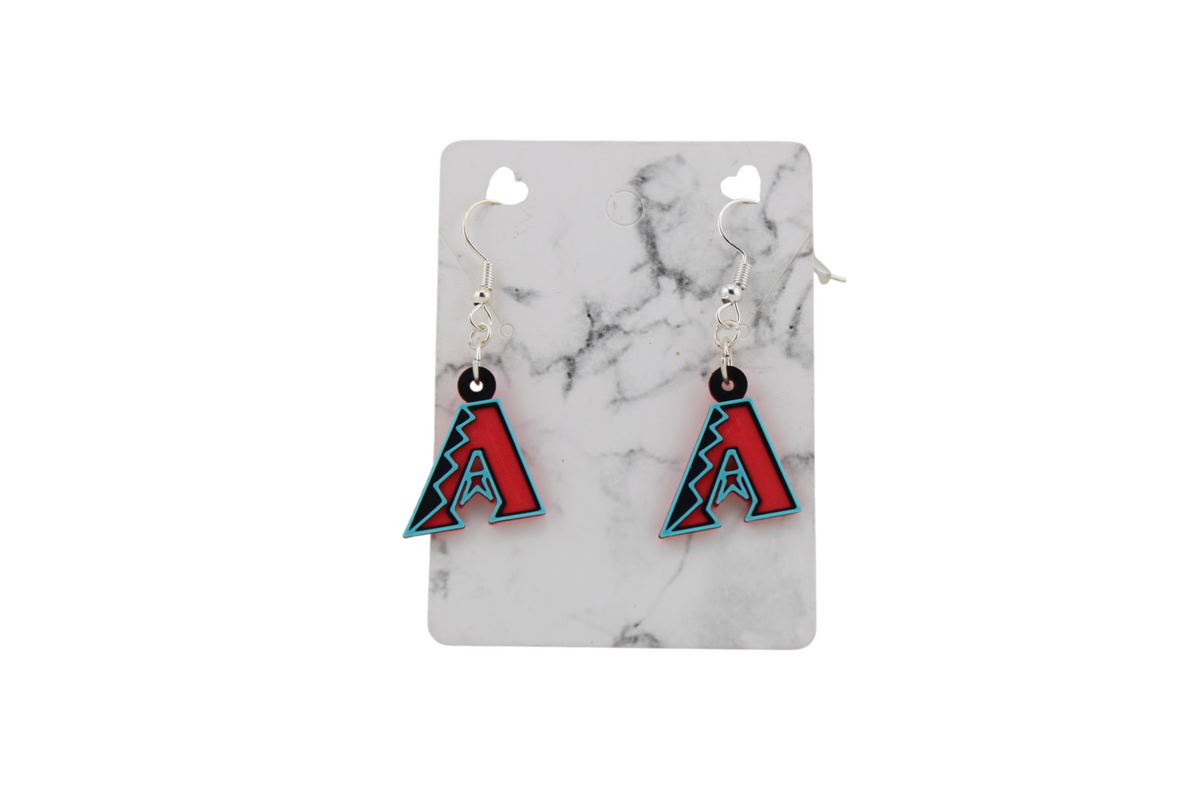 Small 3D printed Arizona Diamondbacks logo dangle earrings with black, red, and teal accents on a white marble display card.