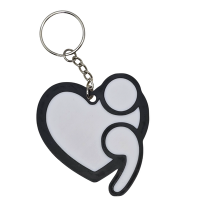 Keychain with a black heart shape and white interior on a white background