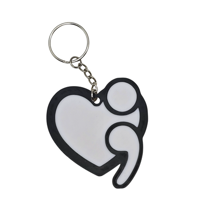 Heart-shaped keychain with a white center and black outline on a white background