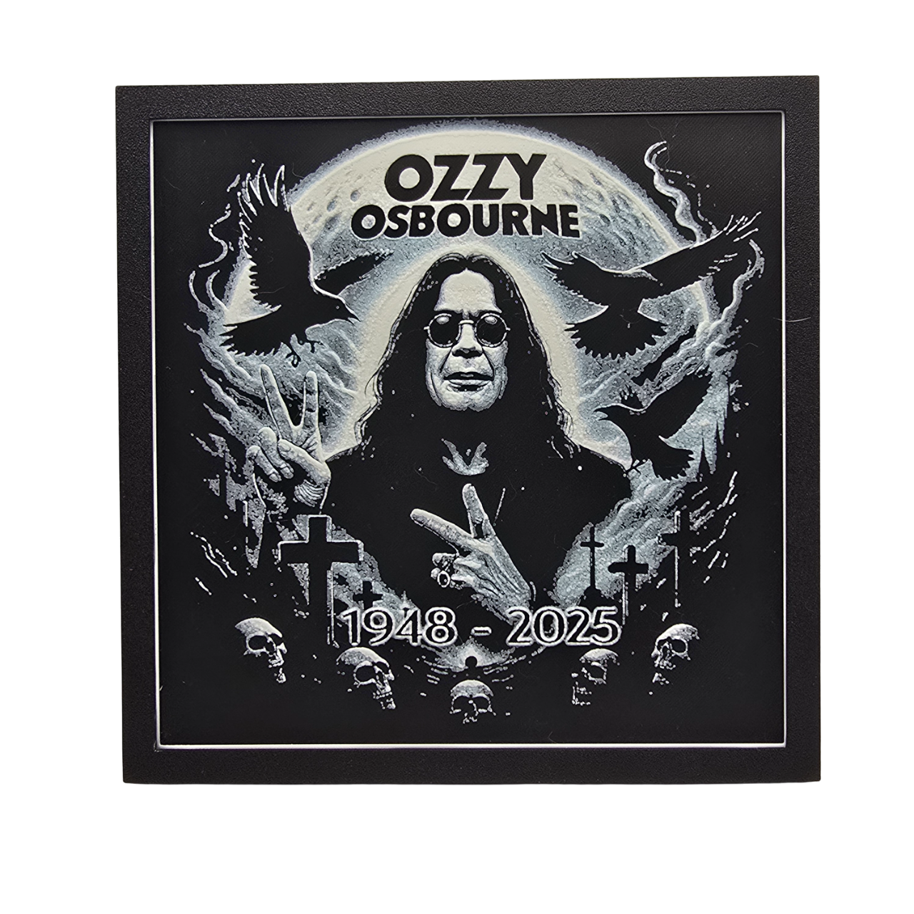 Framed memorial painting for Ozzy Osbourne with crows, skulls, and cross symbols and birth and death years on a black background.