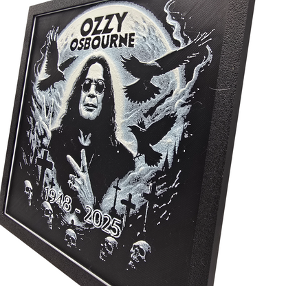 Framed memorial painting for Ozzy Osbourne with crows, skulls, and cross symbols and birth and death years on a black background.