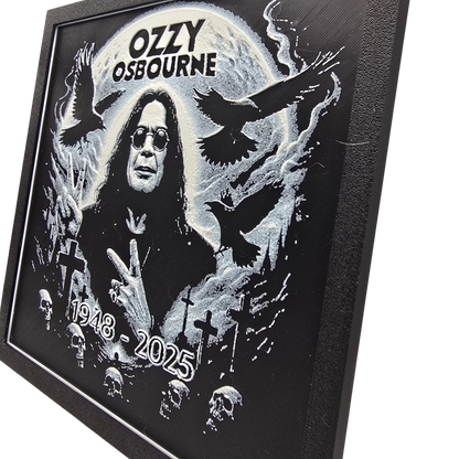 Framed memorial painting for Ozzy Osbourne with crows, skulls, and cross symbols and birth and death years on a black background.