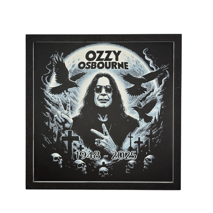 Framed memorial painting for Ozzy Osbourne with crows, skulls, and cross symbols and birth and death years on a black background.
