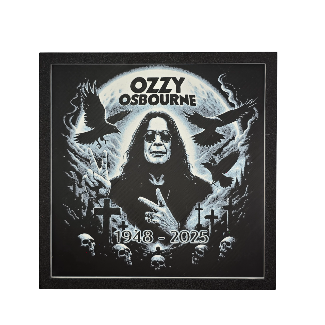 Framed memorial painting for Ozzy Osbourne with crows, skulls, and cross symbols and birth and death years on a black background.