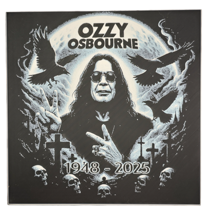 Framed memorial painting for Ozzy Osbourne with crows, skulls, and cross symbols and birth and death years on a black background.