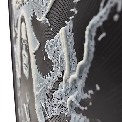 close up side view of Framed memorial painting for Ozzy Osbourne with crows, skulls, and cross symbols and birth and death years on a black background.