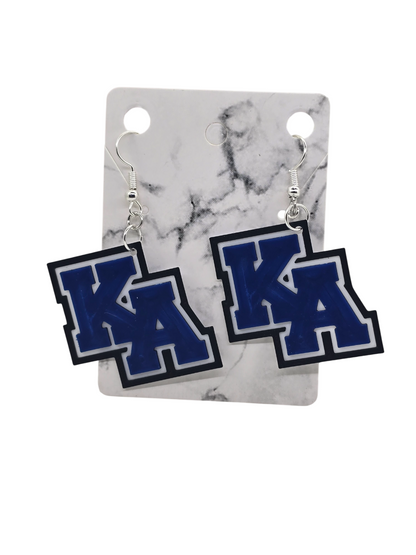 Pair of earrings with 'KA' design on a marble card
