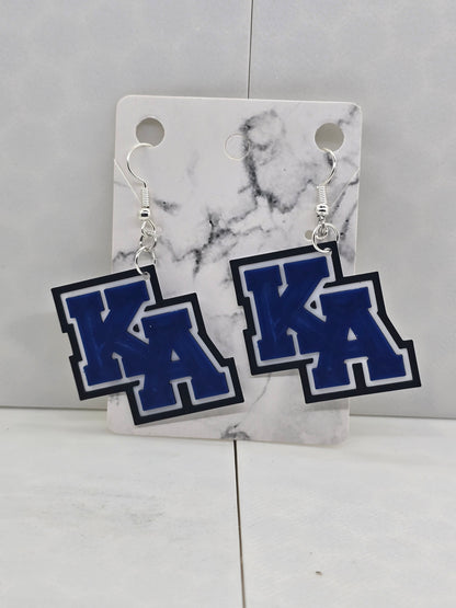 Blue and white earrings on a marble card against a light gray background