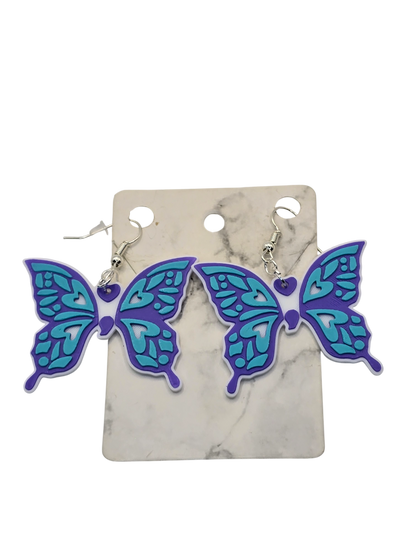 Butterfly-shaped earrings on a marble background