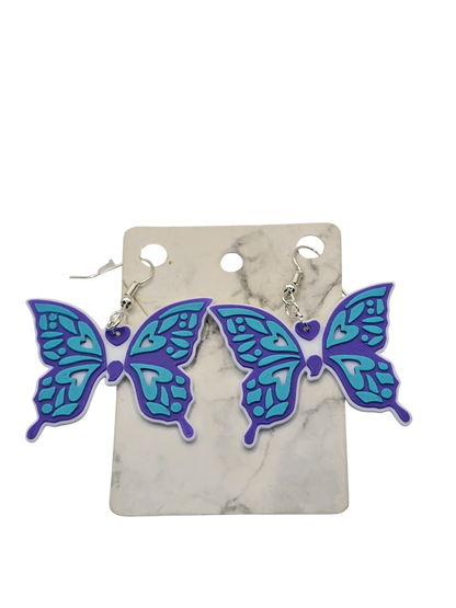 Butterfly-shaped earrings on a marble card with a white background