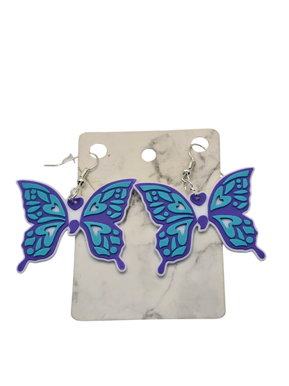 Butterfly-shaped earrings on a marble background