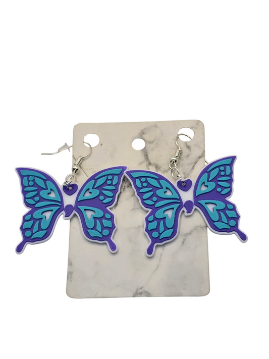 Butterfly-shaped earrings on a marble background