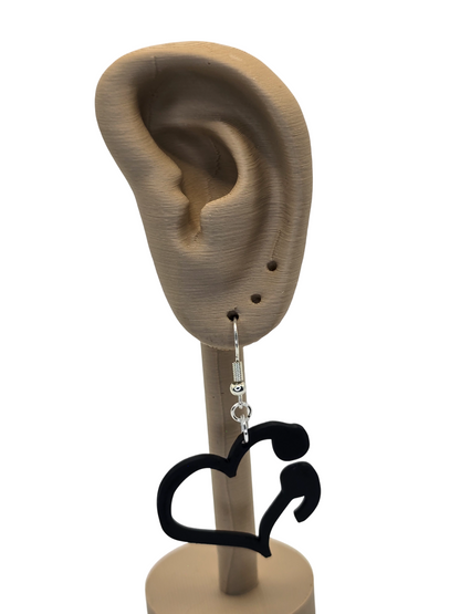 Black heart-shaped earring on a 3d printed ear model with a white background