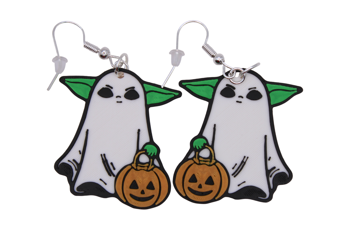 3D printed Ghost Grogu earrings featuring the alien in a ghost sheet holding a pumpkin bucket.