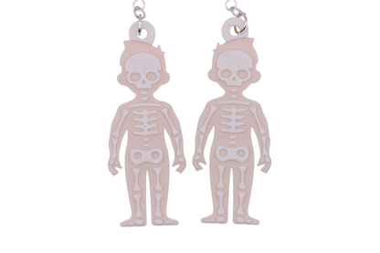 Two large beige skeleton earrings with white layered bone details, shown side by side on metal hooks.