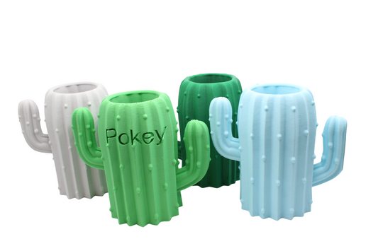 Four 3D-printed cactus-shaped pencil holders in white, green, and light blue with textured surfaces.