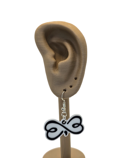 Earring with a black and white infinity design displayed on a 3d printed ear model.