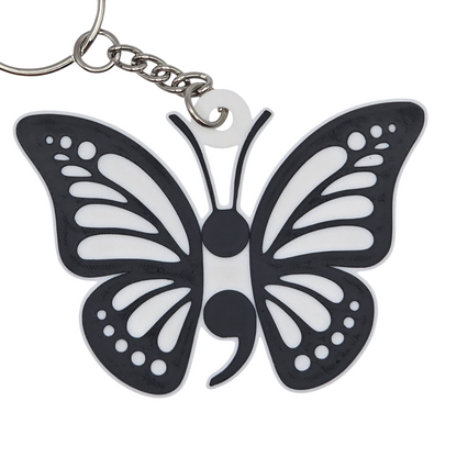 Butterfly-shaped keychain with a black and white design on a white background