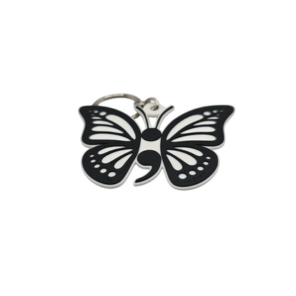 Butterfly-shaped keychain with a semicolon symbol on a white background