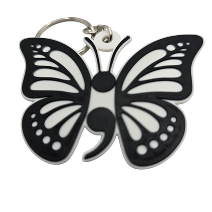 Black and white butterfly-shaped keychain on a white background