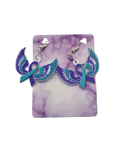 Earrings with teal ribbons and purple wings on a purple and white card
