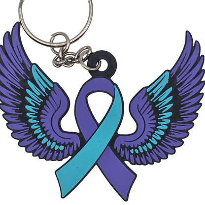 Keychain with teal and purple wings and a teal and purple ribbon on a white background