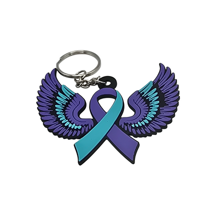 Keychain with teal and purple wings and a teal and purple ribbon on a white background