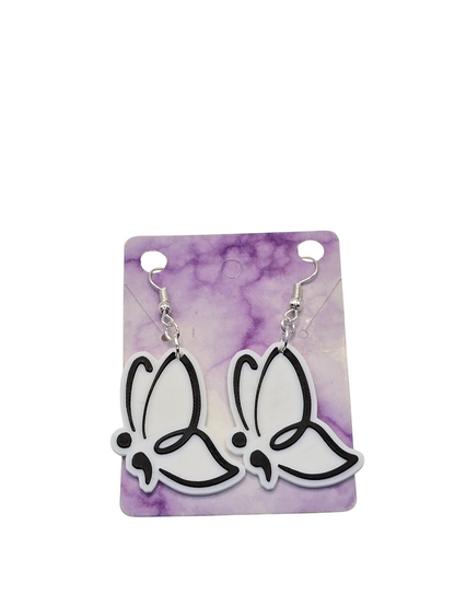 Butterfly-shaped earrings on a purple and white card