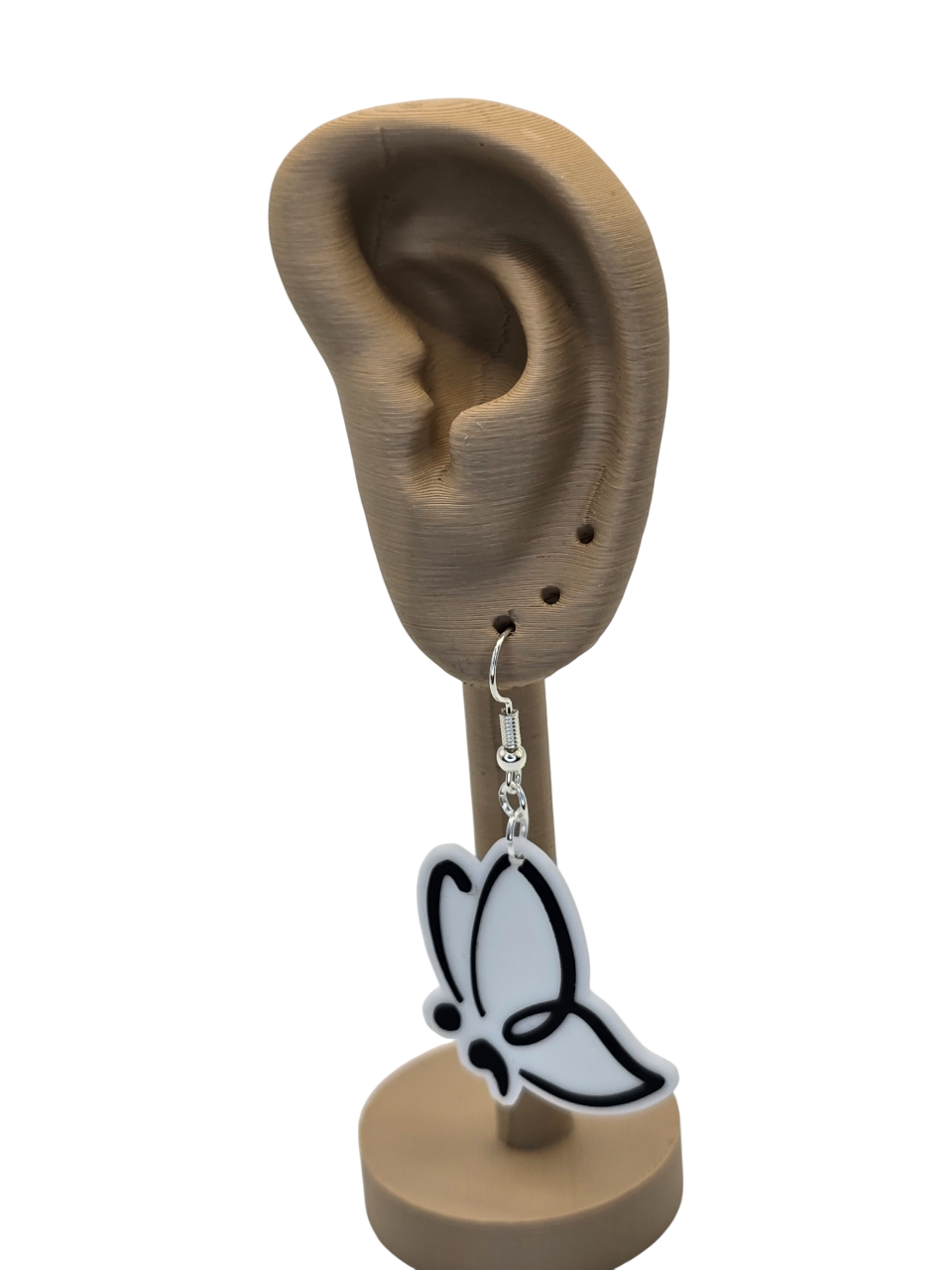 Butterfly-shaped earring on a 3d printed ear model