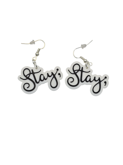 Pair of earrings with 'Stay ;' text on a white background