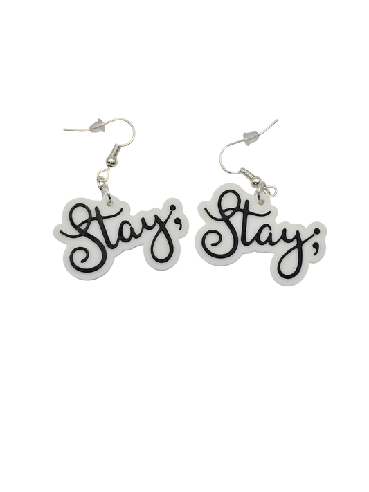Pair of earrings with 'Stay ;' text on a white background