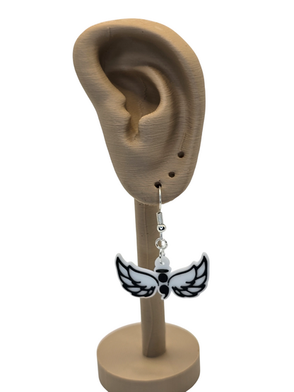 wing-shaped with a semicolon earrings displayed on a 3d printed mannequin ear with a white background