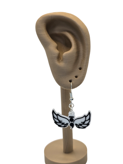 wing-shaped with a semicolon earrings Earring displayed on a 3d printed mannequin ear with a white background