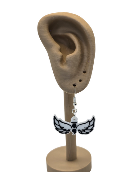 wing-shaped with a semicolon earring displayed on a 3d printed mannequin ear with a white background