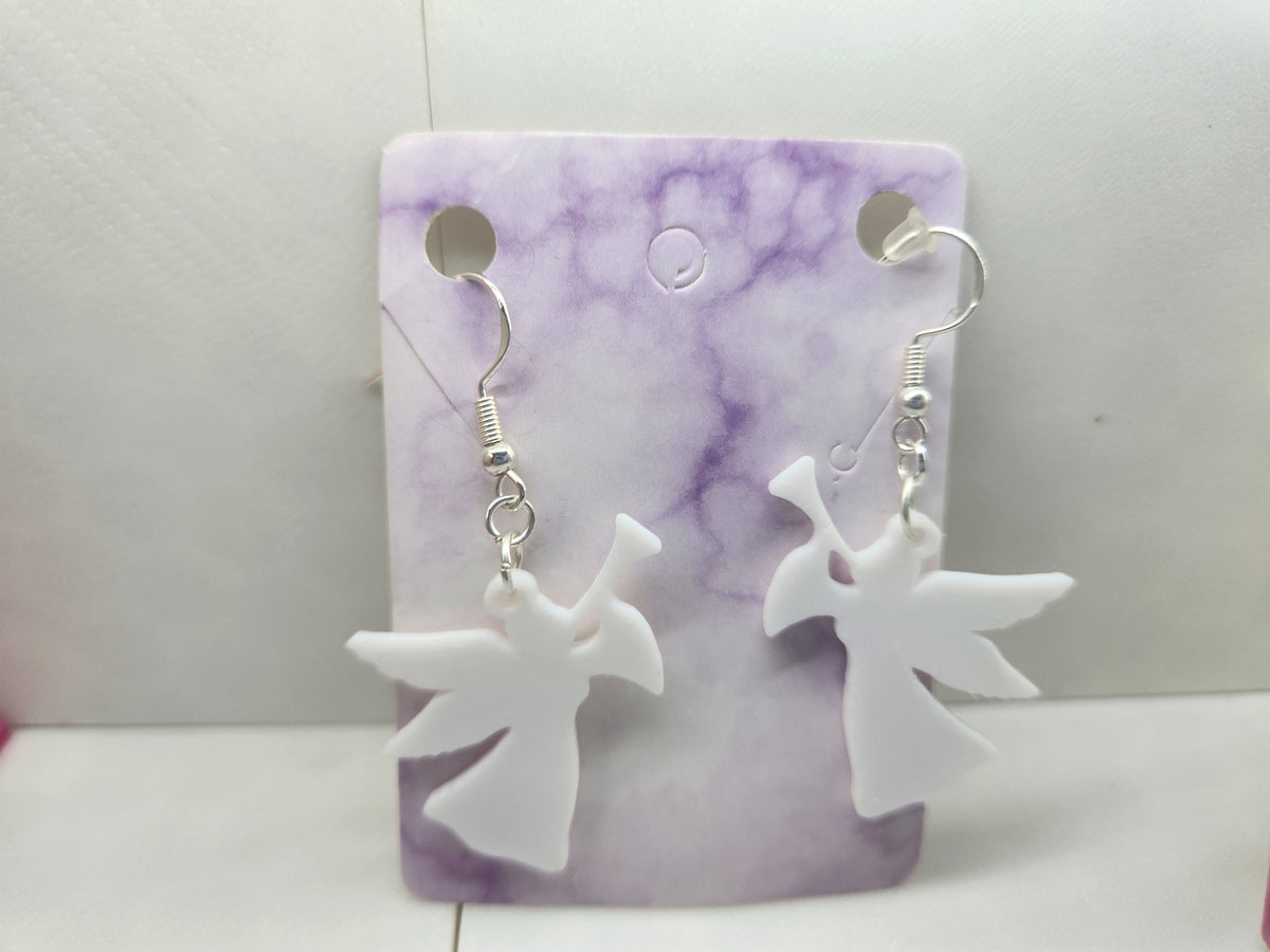 White 3D printed angel horn earrings on a purple marble display card.