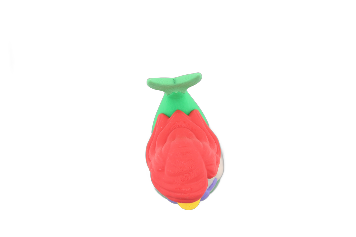 Back three-quarter view of the 3D printed Ariel duck with long red hair flowing over her green mermaid body and raised tail fin