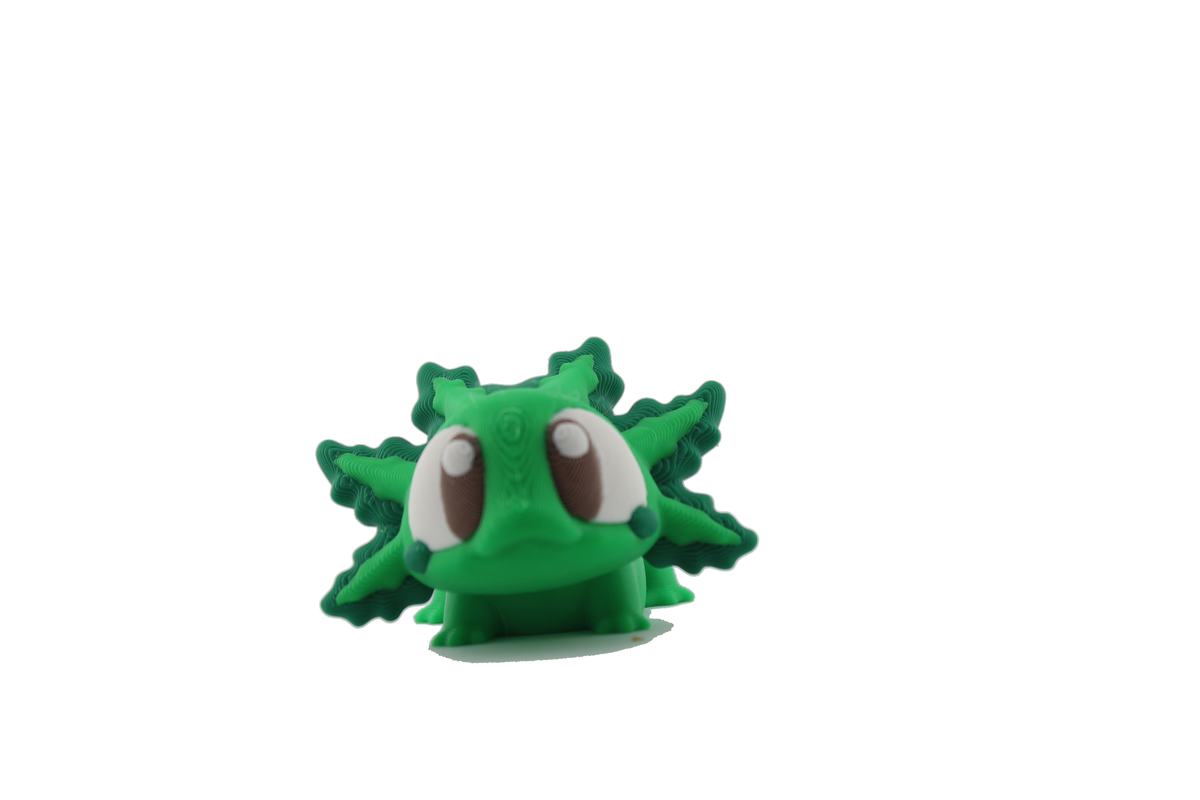 Front three-quarter view of the 3D printed axolotl flexi with bright green body, dark green gills and big brown-and-white eyes