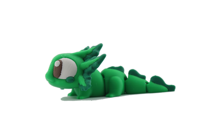 Low side view of the 3D printed green axolotl flexi facing left with one big brown eye and dark green tail fin