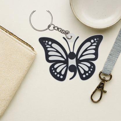 Butterfly-shaped keychain with a lanyard on a light surface