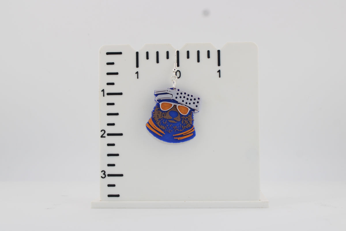 3D printed Chicago Bears bear head earring photographed next to a ruler showing approx. 2 inch height for size reference.