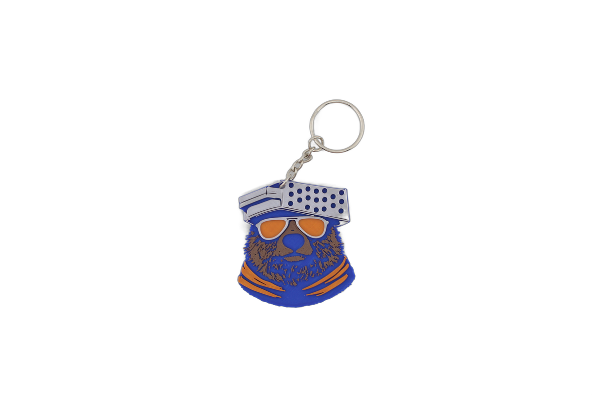 Side view of 3D printed Chicago Bears bear head keychain showing the layered blue, brown, and orange 3D print detail.