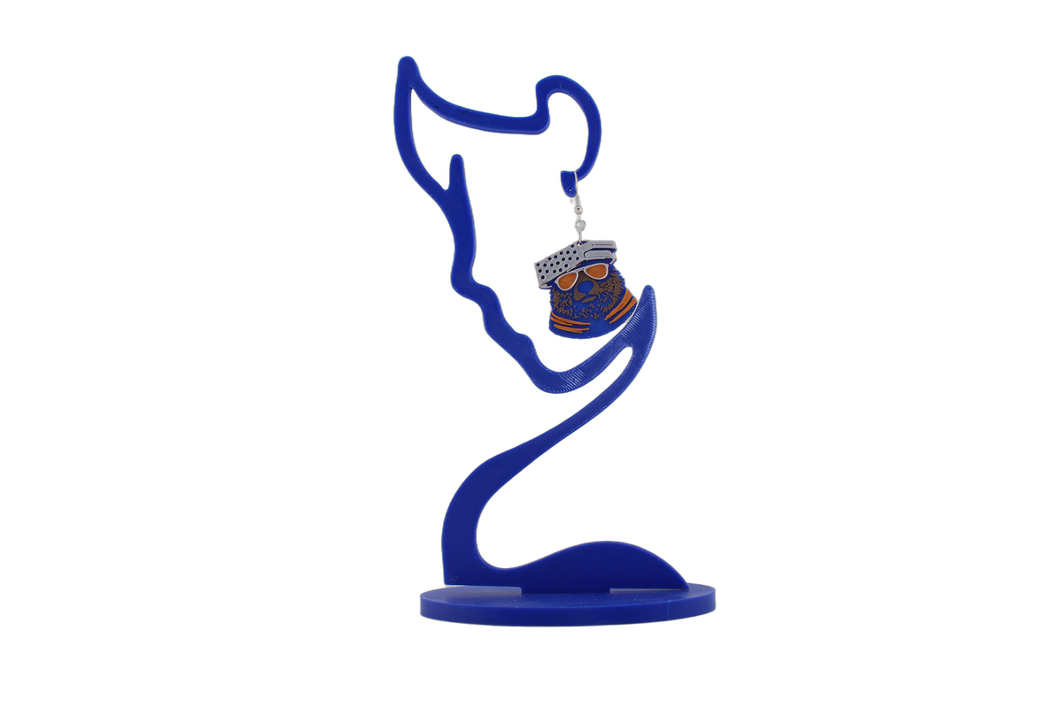 Lone 3D printed bear head earring on a blue display stand — Chicago Bears colors with orange sunglasses.