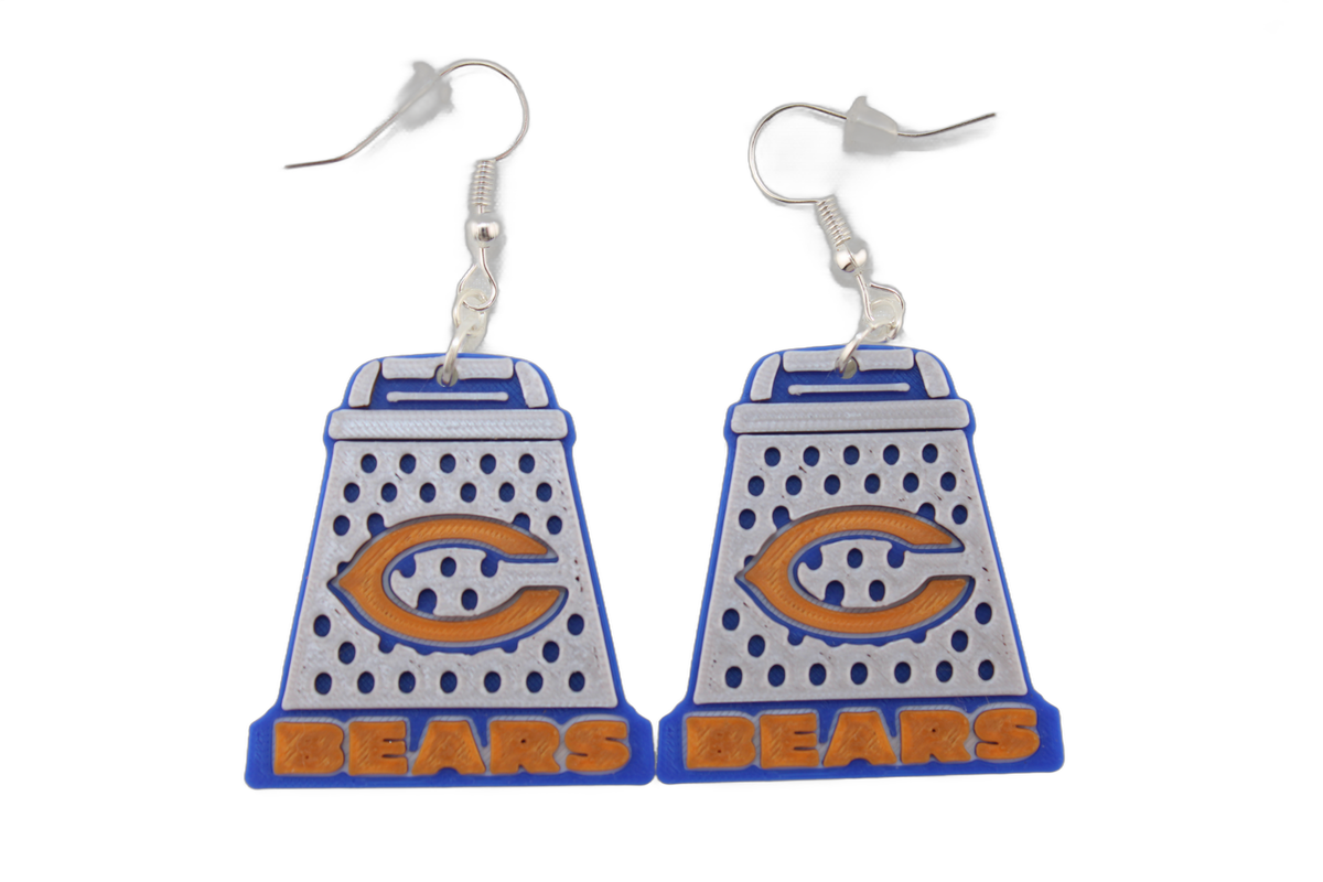 Pair of large 3D printed Chicago Bears cheese grater earrings with prominent orange C logos and BEARS lettering at the base.