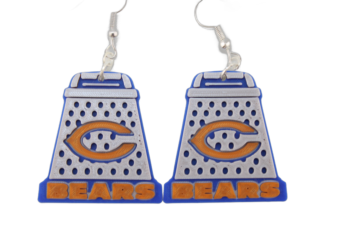 Close-up pair of 3D printed cheese grater earrings — detailed view of the orange C logo on blue and white.