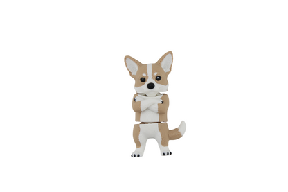 Full-body front view of a tan, white and black 3D printed corgi figurine standing with crossed front paws, tall ears and its tail curved to one side, made by Erratically Eccentric Creations.