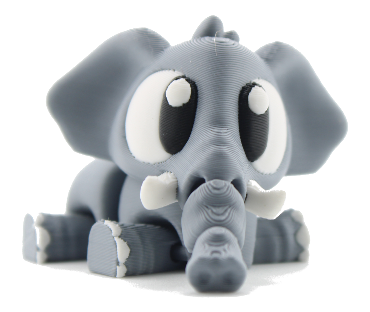 3D printed baby elephant lying down in a front close-up, gray with big eyes, white tusks and its trunk reaching toward the camera